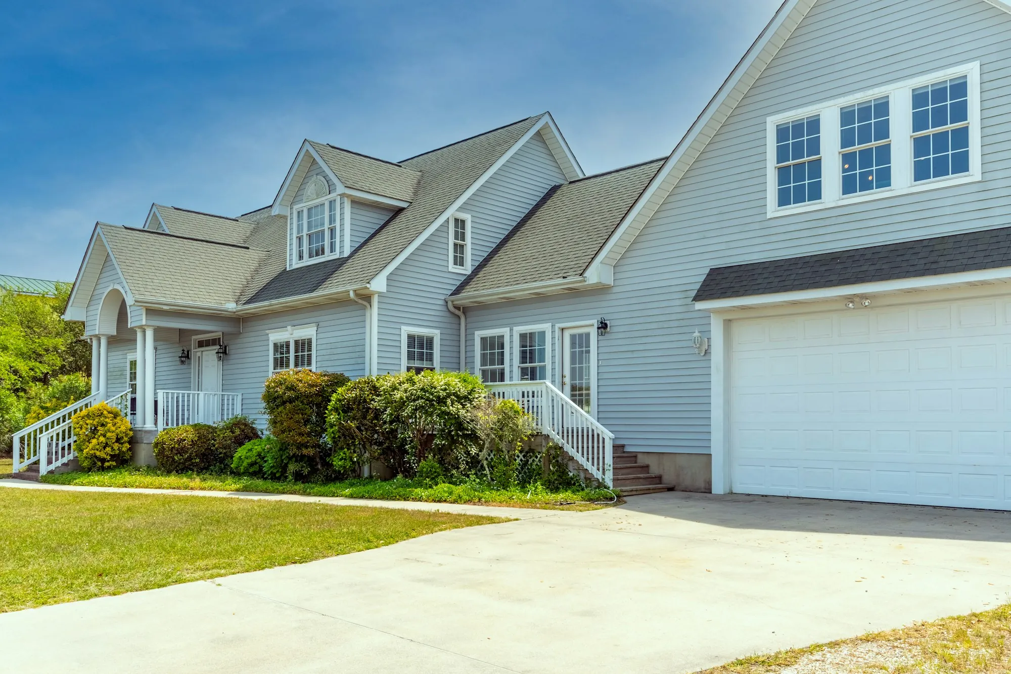 Gray two-story house with a two-car garage and driveway
